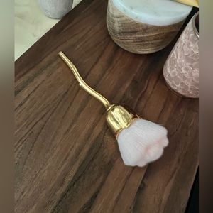 Large fluffy rose cut makeup brush for liquid and powder cosmetics.